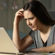 confused woman with laptop